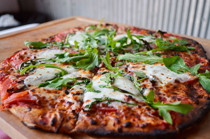 Classic Catering and Events Wood Fired Pizza topped with Arugula